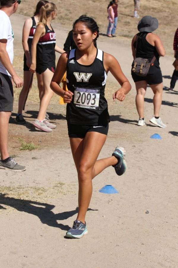 Serena Lo (11) finishes her first mile during the SoCal Invite, Oct. 12, 2019.