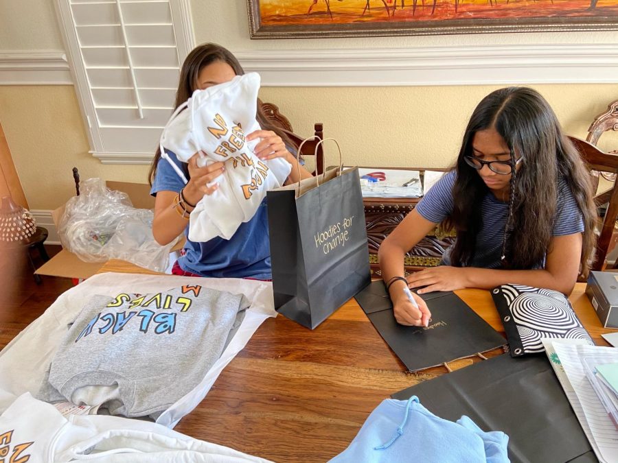 Isabelle and Sofia Rodrigues put together packages to ship out. Their business takes up a specific room in their house, and the girls work together to ship out their merchandise.