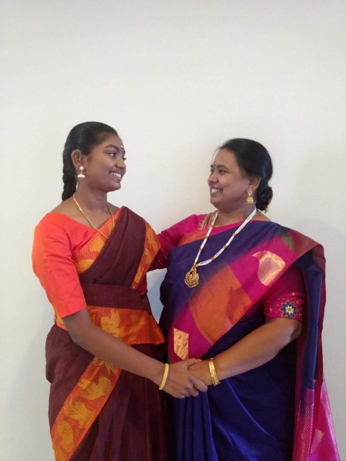 Aditi Anand (10) talking with her mother during a day of the traditional Hindu Festivals of Auspicious Nine Nights or Navaratri.” Anand is wearing the costume she wears for bharatanatyam dancing.