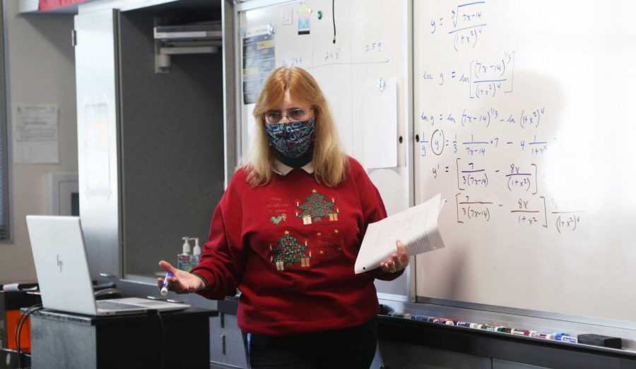 Vanderby teaches to students on Zoom and in the classroom in front of her whiteboard simultaneously, Dec. 11. Her current configuration means that students in the video classroom see the same things her in-person students do in real time. Photo taken by Amy Wang.