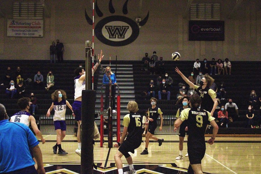 Outside hitter Caden Sajnog (11) attacks, scoring a point in the tight first game.