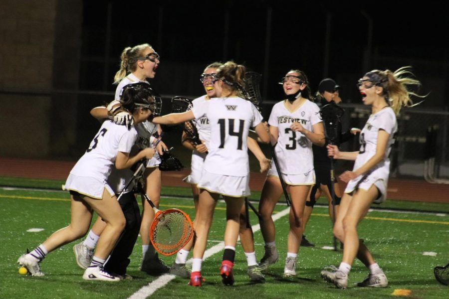 Team members celebrate after they win 13-12  against Canyon Crest Academy on May 7.