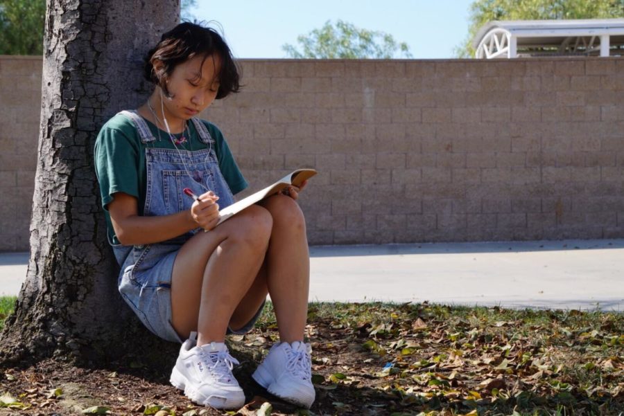 Grace He (11) listens to music while journaling her thoughts to de-stress. As a competitive figure skater, He grapples with the ex-ternal pressures of her sport