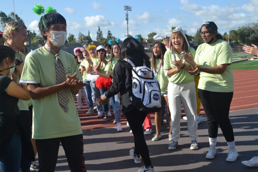 From left to Right, Eric Yang (12), Katelee Dinh (12), and Anandi Radhakrishnan (12) welcome the incoming Juniors to Unity Day on the football field. the three alongside many other seniors applied to be facilitators to bond with, and help connect the juniors with one another. Photo by Matthew Flores