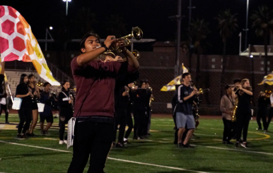 Carson Parel (11) preps his horn to play during a practice run of GOLD's show, Sept. 28. GOLD will compete at the Rancho Bernardo Field Tournament Saturday.