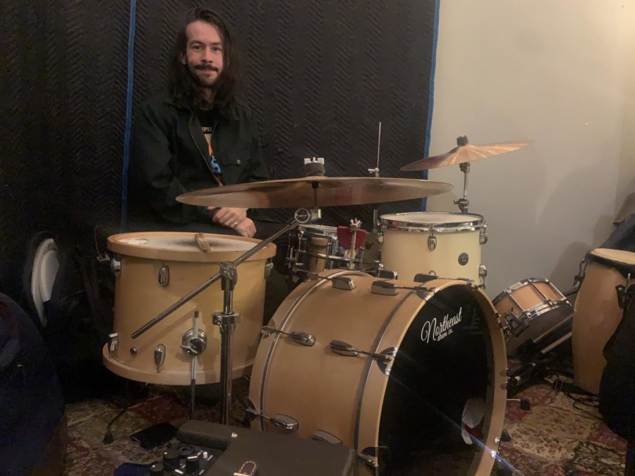 Marc Finn sits before his drum-set in his practice room. Finn has been a part of popular surf-punk band, The Frights since 2014.