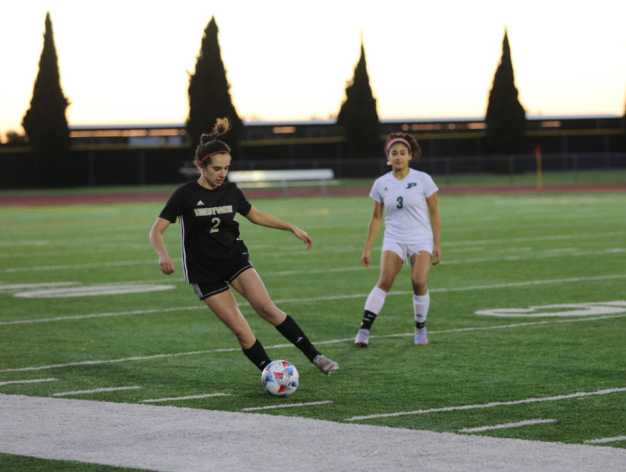 Mackenzie Camara (12) dribbles the ball down the field during the home game against Poway, Feb. 4. Westview won 1-0 and celebrated senior night, where Camara was honored along with six other seniors for their time and commitment to the team. (Photo by Cara Tran)