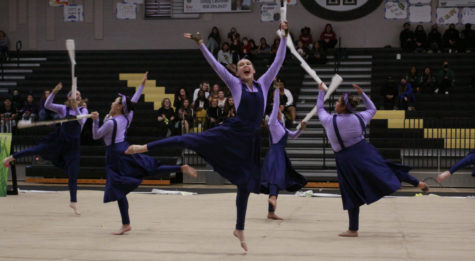 Mia Remer (11) leaps into the air with her rifle in the Winter Guards performance, “A Beginner’s Guide to Gardening,” at Westivew, April 2. Westview hosted its first Winter Guard tournament in over 15 years, where the team received second place in the Scholastic A division.