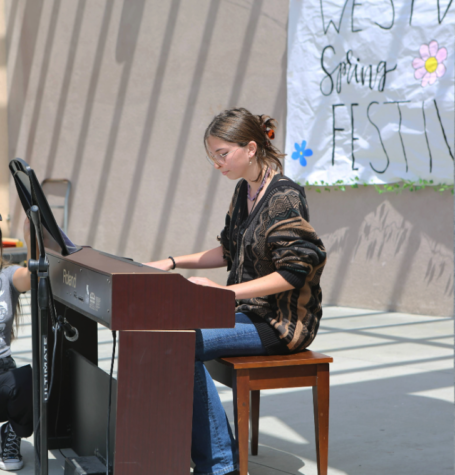 Julia Smith (9) plays the piano during auditions for the festival, April 25. Smith chose to perform the song “Merry-go-round of life.”