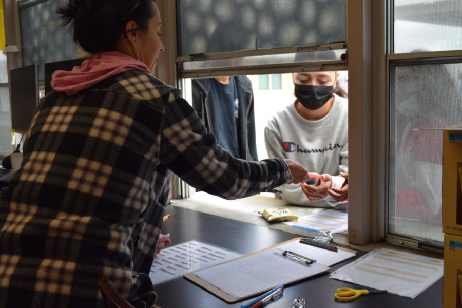 Area Administrator Teri Heard rewards students cashing in their Wolverine Bucks, April 25. Heard is in charge of the Wolverine Bucks program on campus.