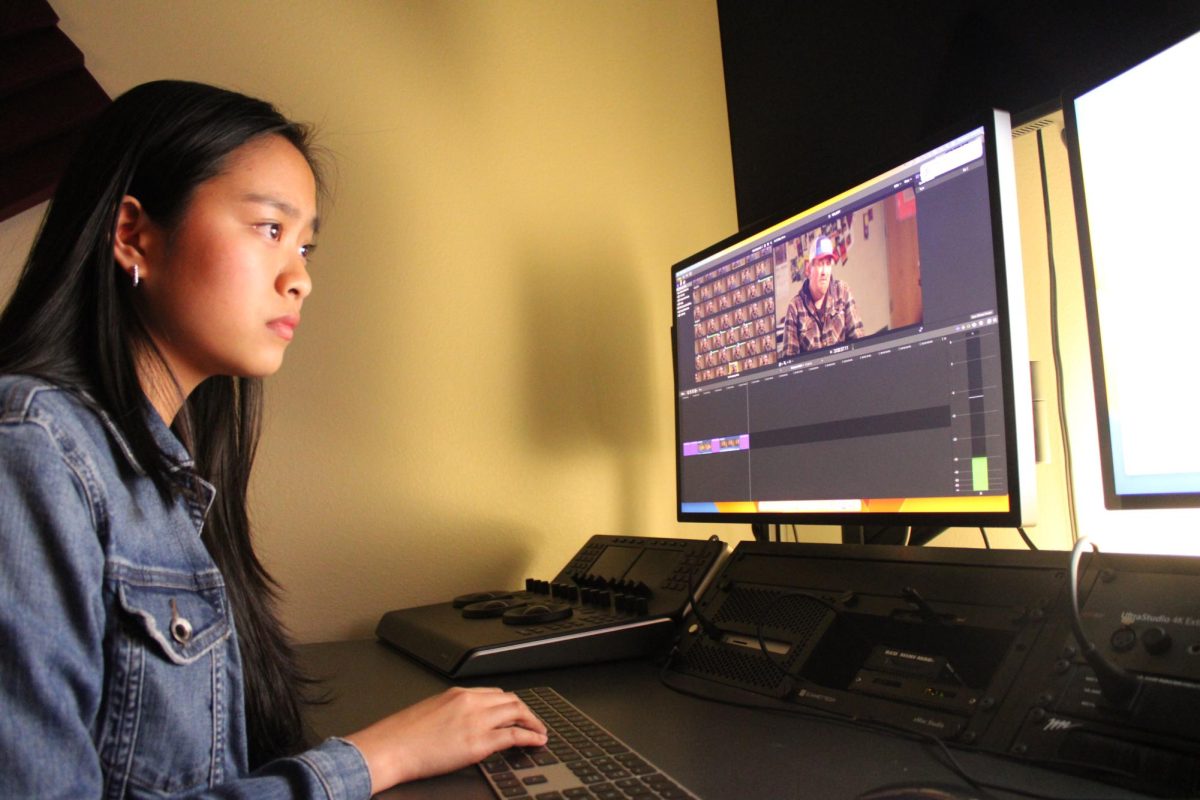 Elena Tran (12) works on matching audio to a PUSD broadcast news video for her internship with studio 701