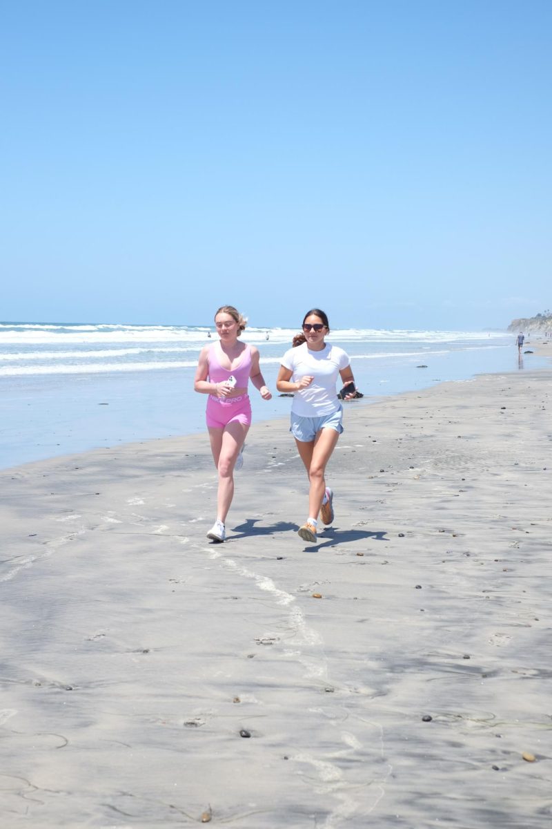 Kamila Nava (11) [right] and Alexi Stysis (11) run at Torrey Pines State Beach, April 27. Nava enjoys going for runs outdoors and tries to run in nature as frequently as possible.