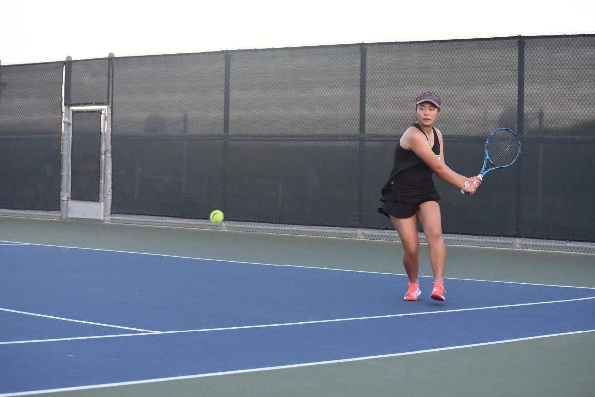 Crystal Chen (12) prepares to hit the ball in her doubles match against Canyon Crest Academy, Sept. 17. She has been captain for two years. 