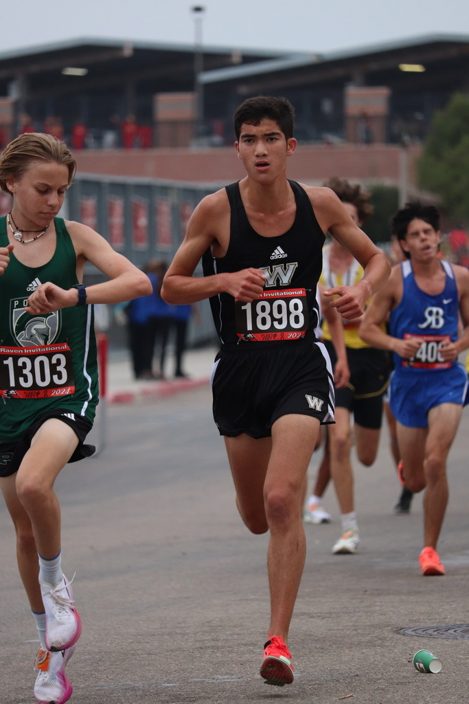 Parker McDevitt (12) races three miles. He ended with a time of 15:27, and placed 17th out of 250.