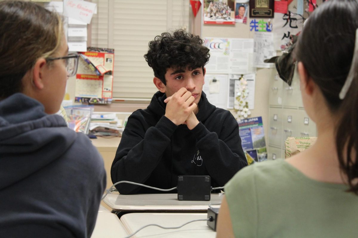 Anvit Watwani (12) listens to the Quiz Bowl moderator's question, deliberating his response, at the CCA tournament, Nov. 16. The team qualified for playoffs with a score of 5-2.