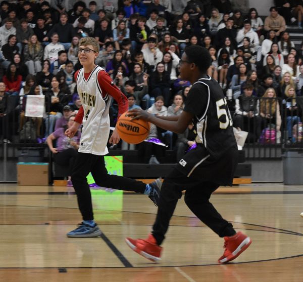 Andrew Porter (10) [left] tracks Ayden Moore (9) [right] at the Unity Basketball Game, Feb. 4. Moore went on to score the tying shot.