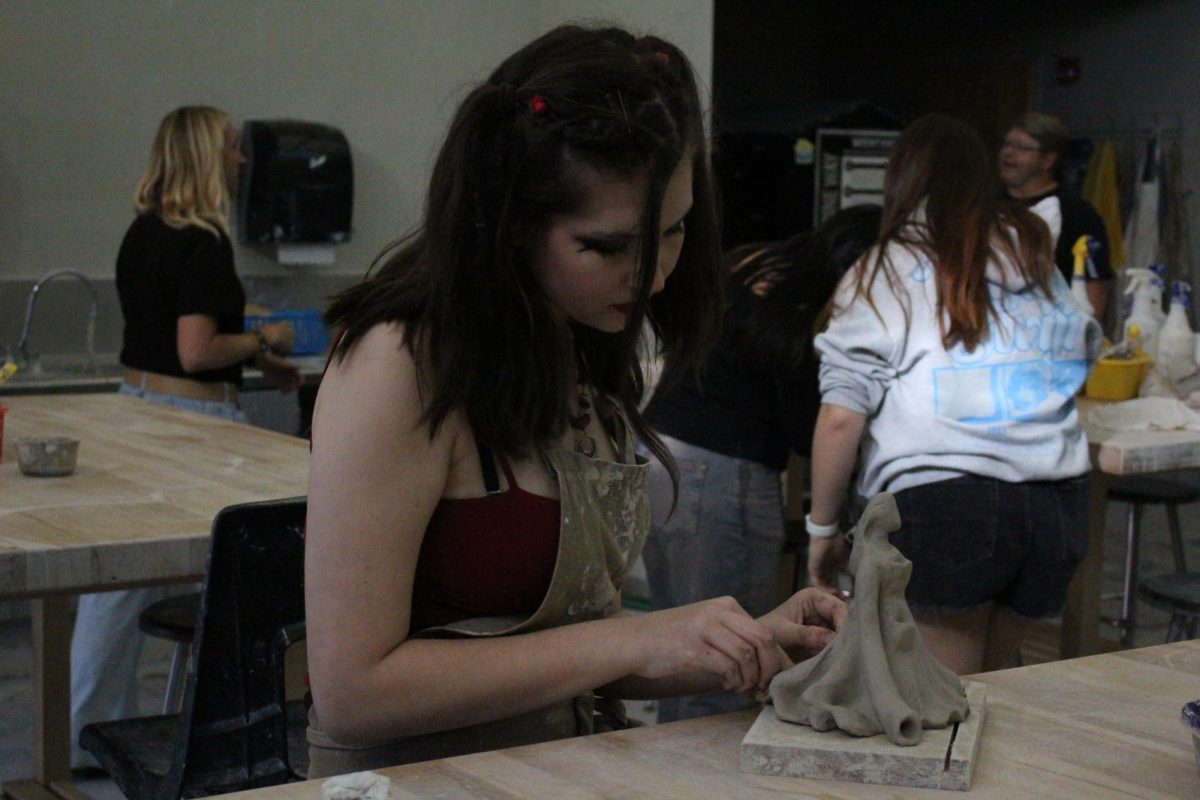 Emily Sechrist (10) finishes her Ceramics 3-4 final titled "Anchored," May 21. Her piece was showcased in the open house.