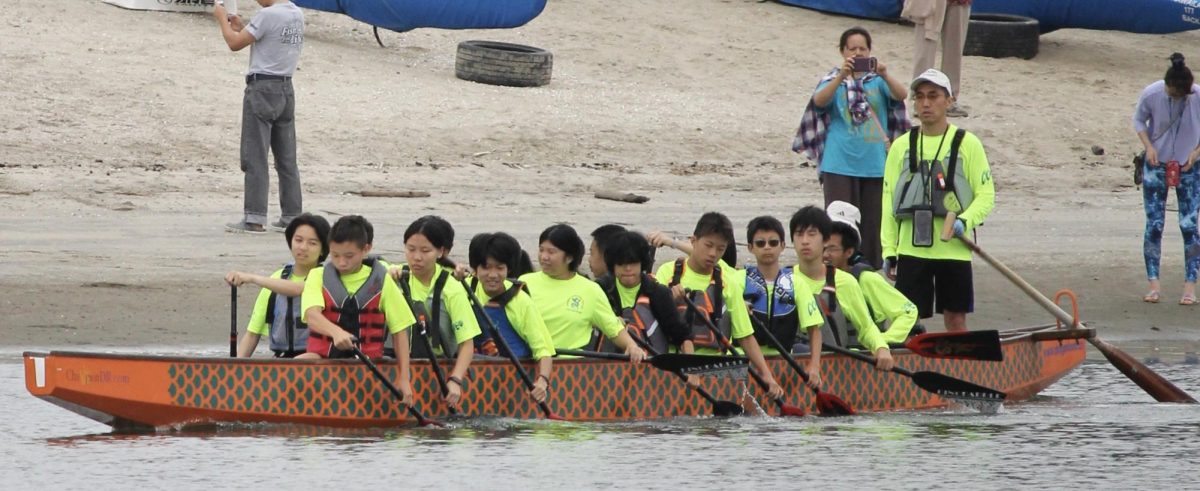 Valen Miao (9) [front] paddles in a dragon boat for Chinese Youth Dragon Boat, Sept. 13. Miao has been racing for one year.