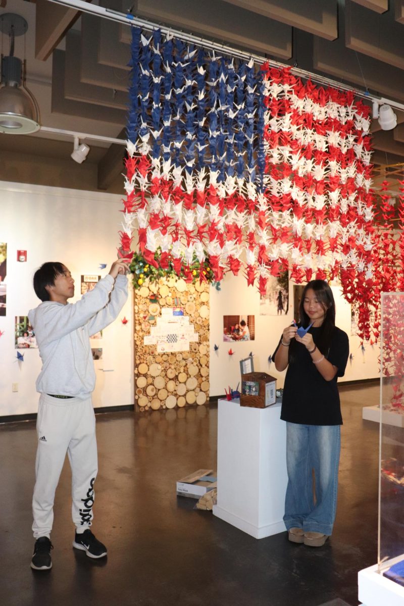 Terri Sun (10) and Albert Li (12) fold cranes, Sept. 6. The origami art is displayed in the Bonita Museum and Cultural Center. 