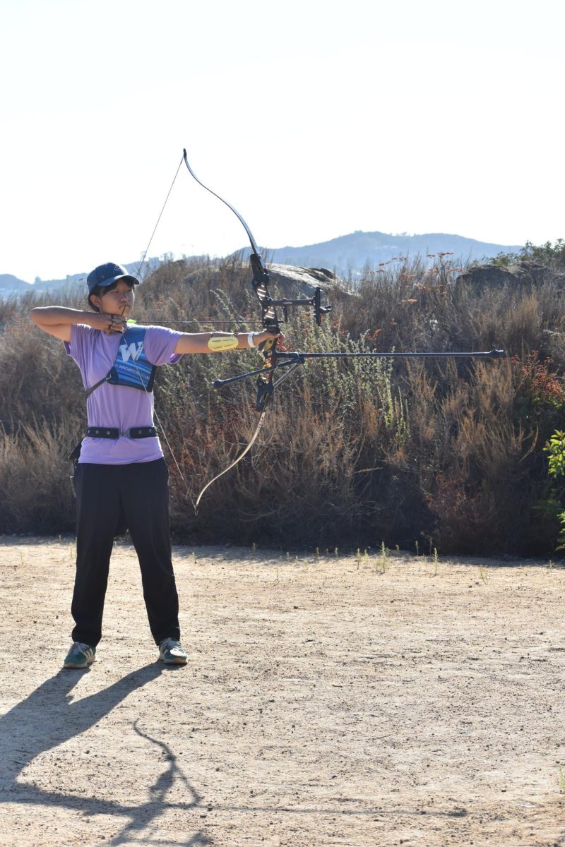Seyoon Park (9) pulls her bowstring, aiming at a target during practice, Sept. 12. She currently holds third place in the country in U15 women with recurve bows, earning her a spot on Team USA.