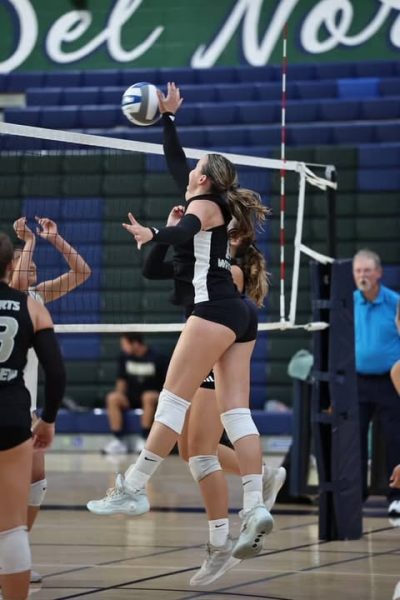 Peyton Erickson (11) spikes the ball to Del Norte's side of the court, Sept. 4. She contributed to the team's offense, with 70% of her hits being kills. (Jennifer Tellers)