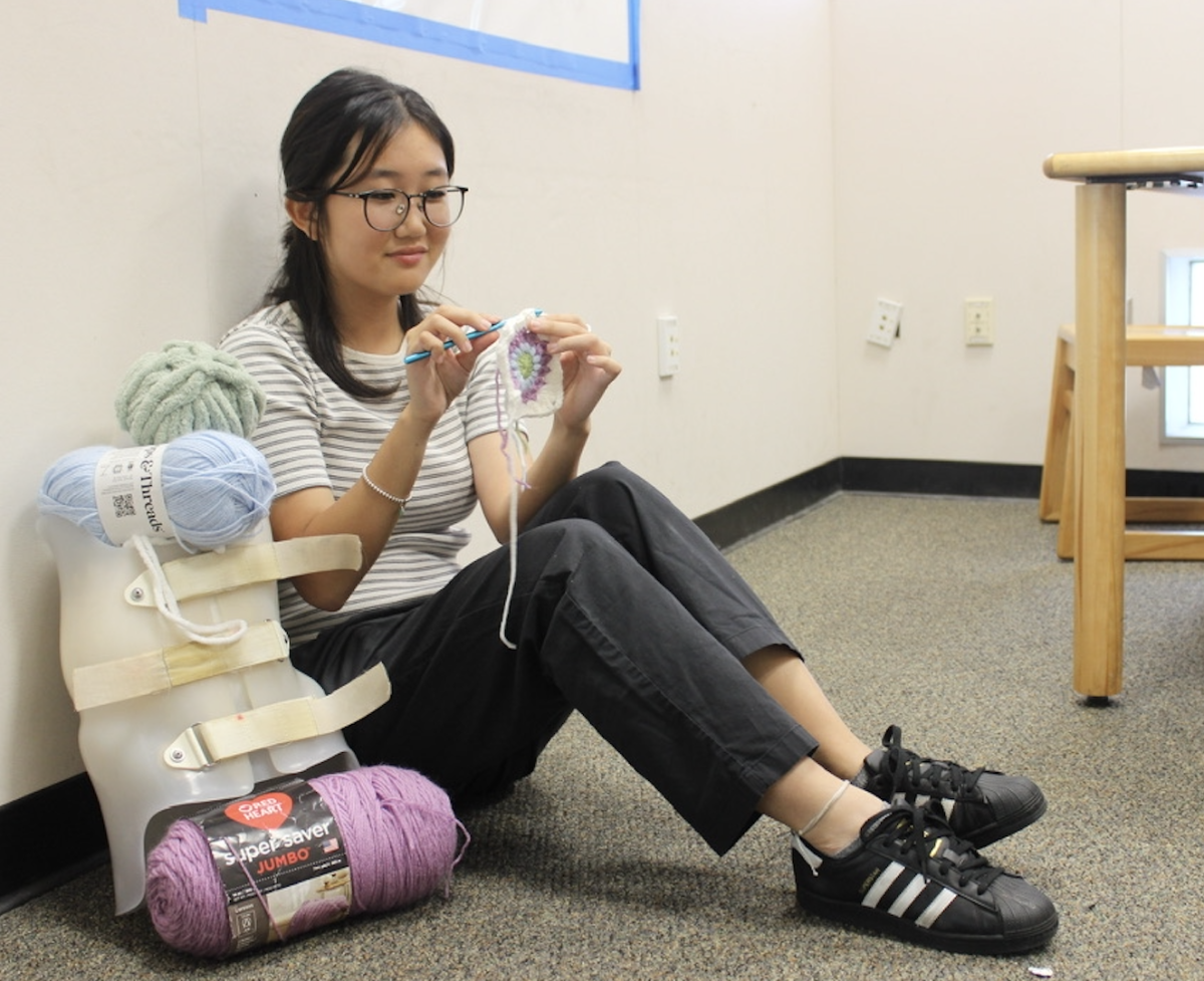 Julia Cheon (12) crochets a coaster for her nonprofit, Straightened Futures, Oct. 2. She donates the proceeds from her crochet projects to charities such as Setting Scoliosis Straight. 