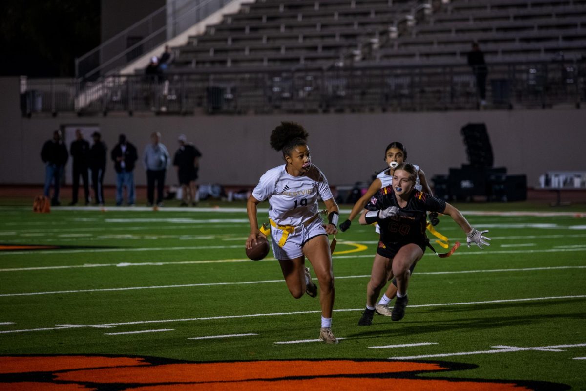 Mya Omisore [left] scrambles to elude a tackler before firing a pass to London Davis (12) at the D-1 CIF championships, Nov. 8. Westview lost the game, 20-13.