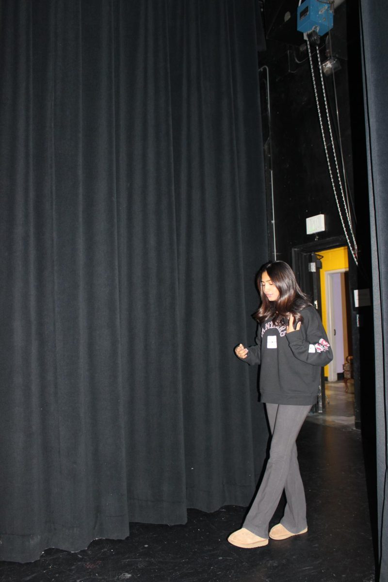 Harshini Patted (12) shakes out her nerves, calming herself before stepping onstage to perform.