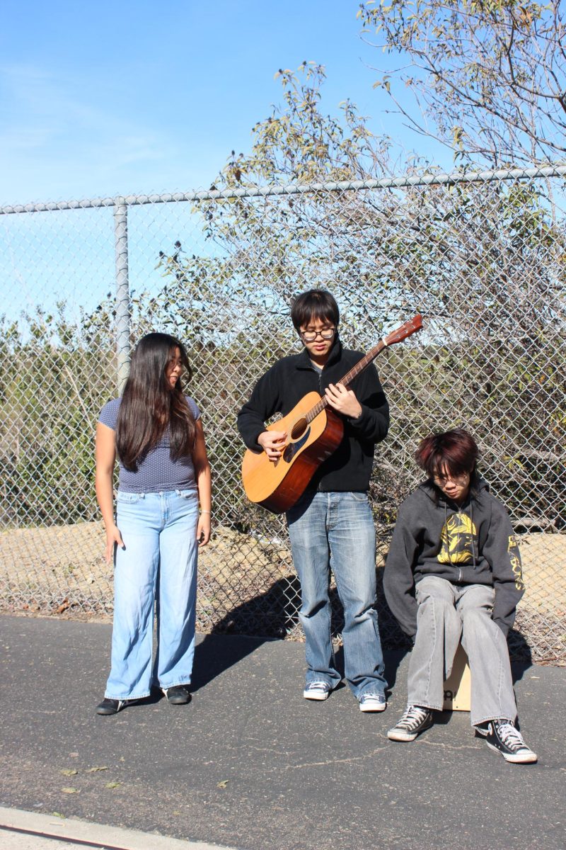 Rosemary Cabanban (12), Brandon Pham (12), and Dylan Bui (12) [left to right] practice "Don't Let Me Down" by The Beatles, Jan. 20. The Three Busketeers busked at Balboa Park and La Jolla Shores. 