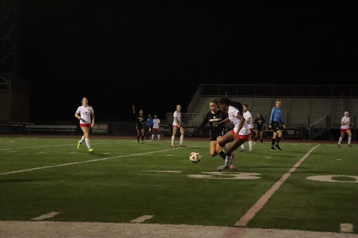 Alexis Ferguson (9) evades MC defenders, pressuring the goal early in the game, Jan. 17. Girls soccer lost 2-1 to the Sundevils. 