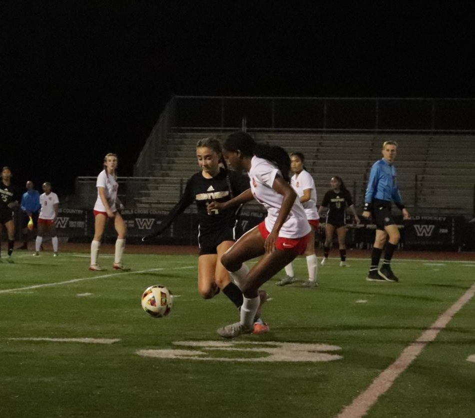 Alexis Ferguson (9) evades MC defenders, pressuring the goal early in the game, Jan. 17. Girls soccer lost 2-1 to the Sundevils. 