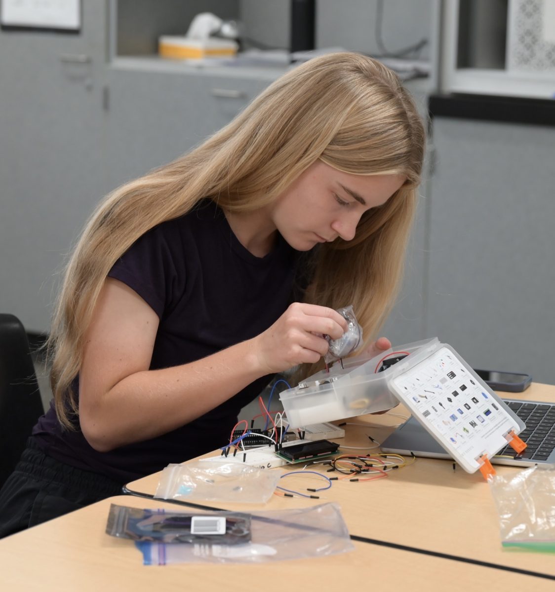 Camrynn Beal (10) wires her Arduino pins and wires to her breadboard. Students from the Girls Who Code and Red Cross club constructed heart monitors from scratch.