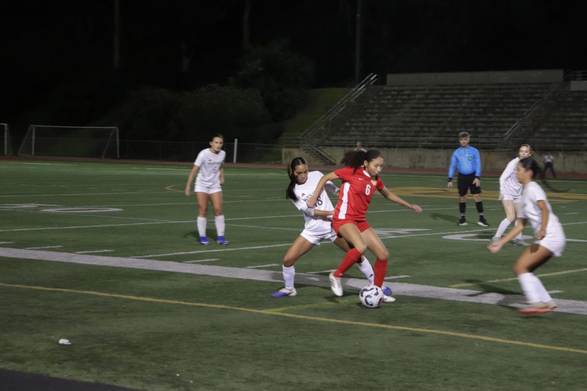 Winger Jordyn Vales (11) successfully steals the ball and advances up the field, Feb4. Girls soccer played against Mt. Carmel for the second time this season, the Wolverines lost 3-2. 
