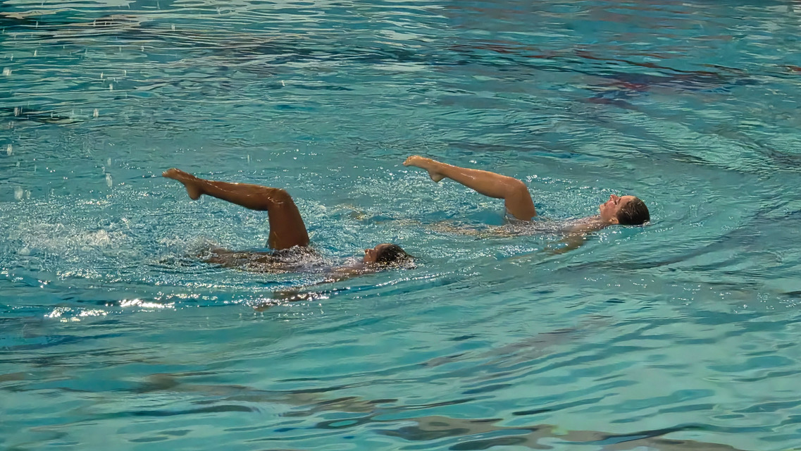 Parise Mason (10) and her partner perform a hyprid element with their legs exiting the water to the theme music of “White Lotus,” April 10. They placed 21st in the Junior Women Duet Technical Event at the Junior Nationals for Artistic Swimming