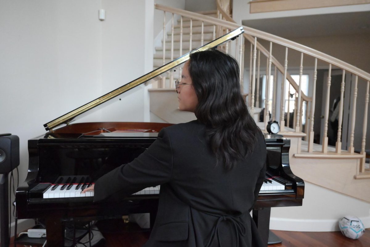Luna Lee (10) plays the Grieg Piano Concerto in A Minor, Op. 16 movement 3 on her grand piano, April 26. Lee has been practicing the piece for seven months.
