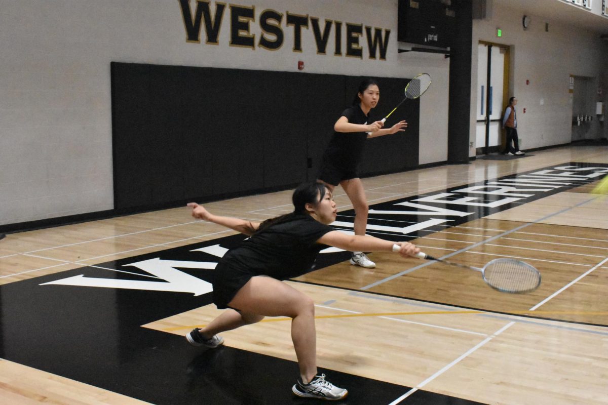 Lydia Tsai (11) lunges for the birdie as her doubles partner, Alice Lau (10), braces for the return from Rancho Bernardo, March 23. Tsai and Lau played to each other's strengths and frequently rotated positions around the court, resulting in a victory of 21-13. 